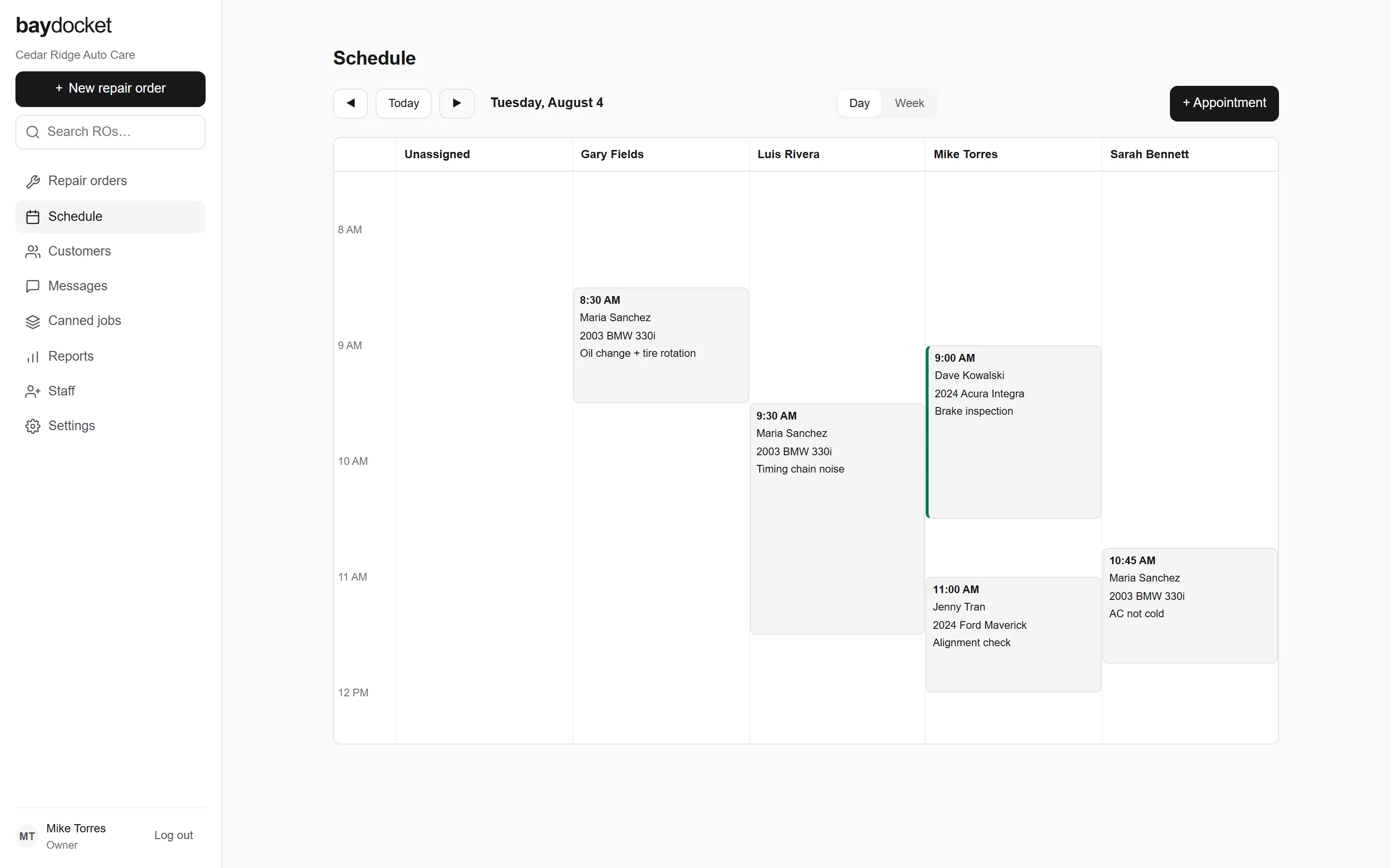 The BayDocket day schedule: a column for each person on the team plus Unassigned, with appointment cards showing time, customer, vehicle, and concern.